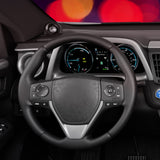Car interior with steering wheel and dashboard against a blurred colorful background