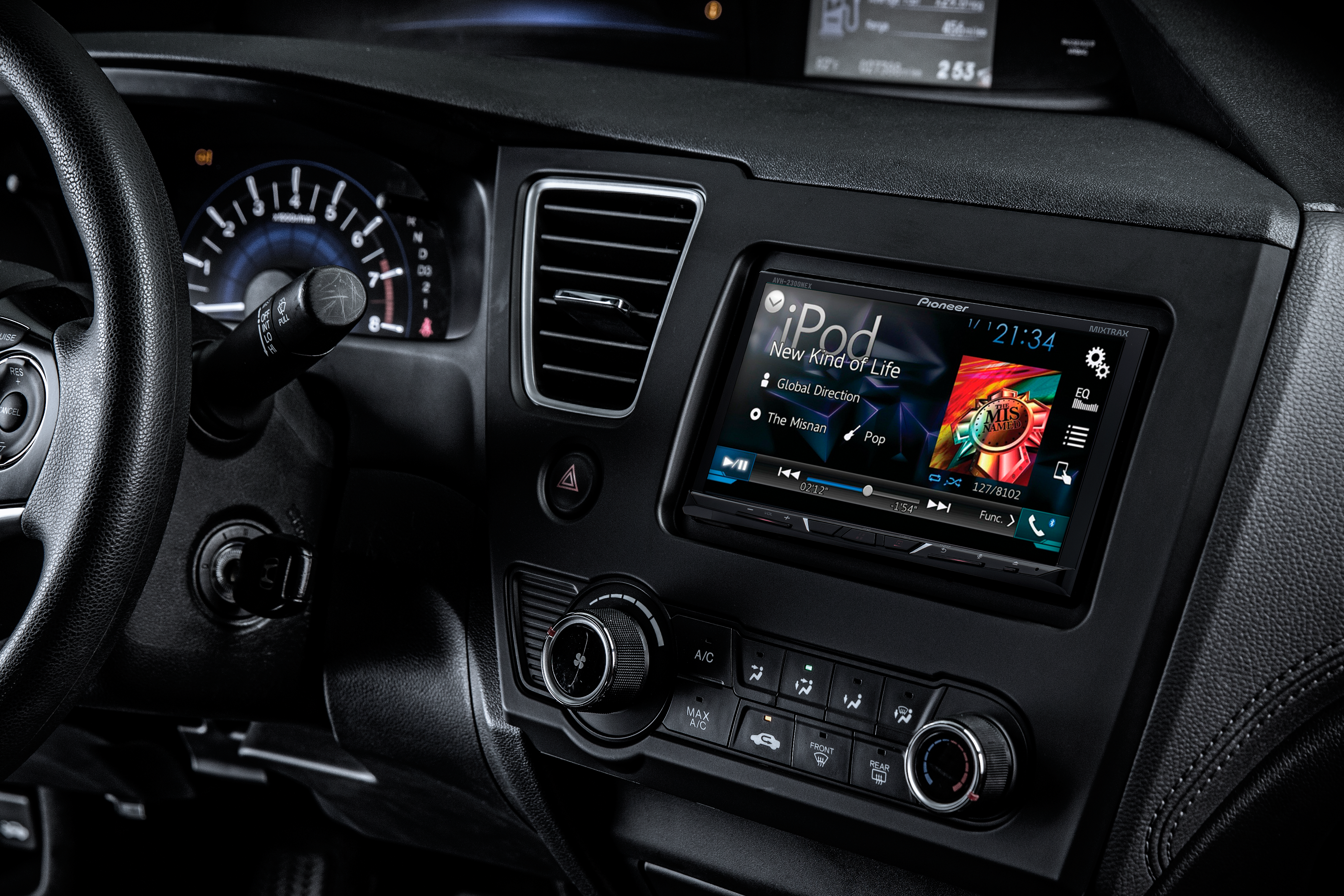 pioneer receiver installed inside a car with iPod music playing from screen