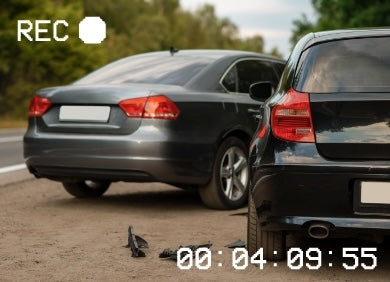 Two cars parked on a road with a bird between them, timecode displayed.