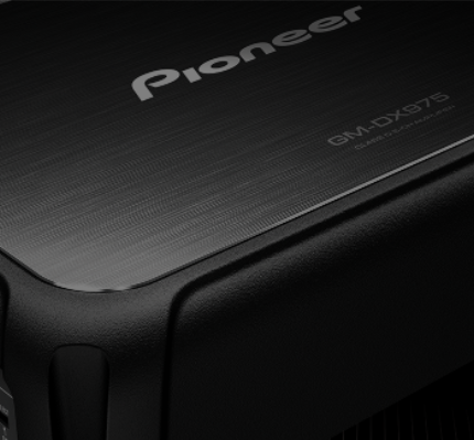 Close-up of a Pioneer car audio amplifier with 'GM-DX975' model number.