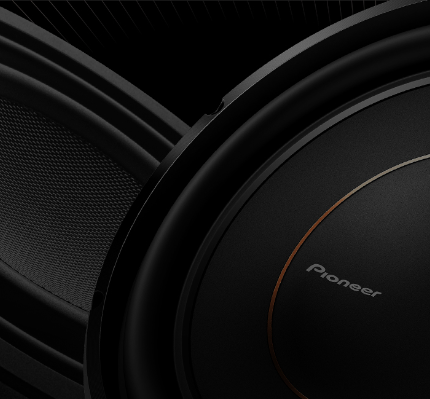 Close-up of a Pioneer car subwoofer on a black background